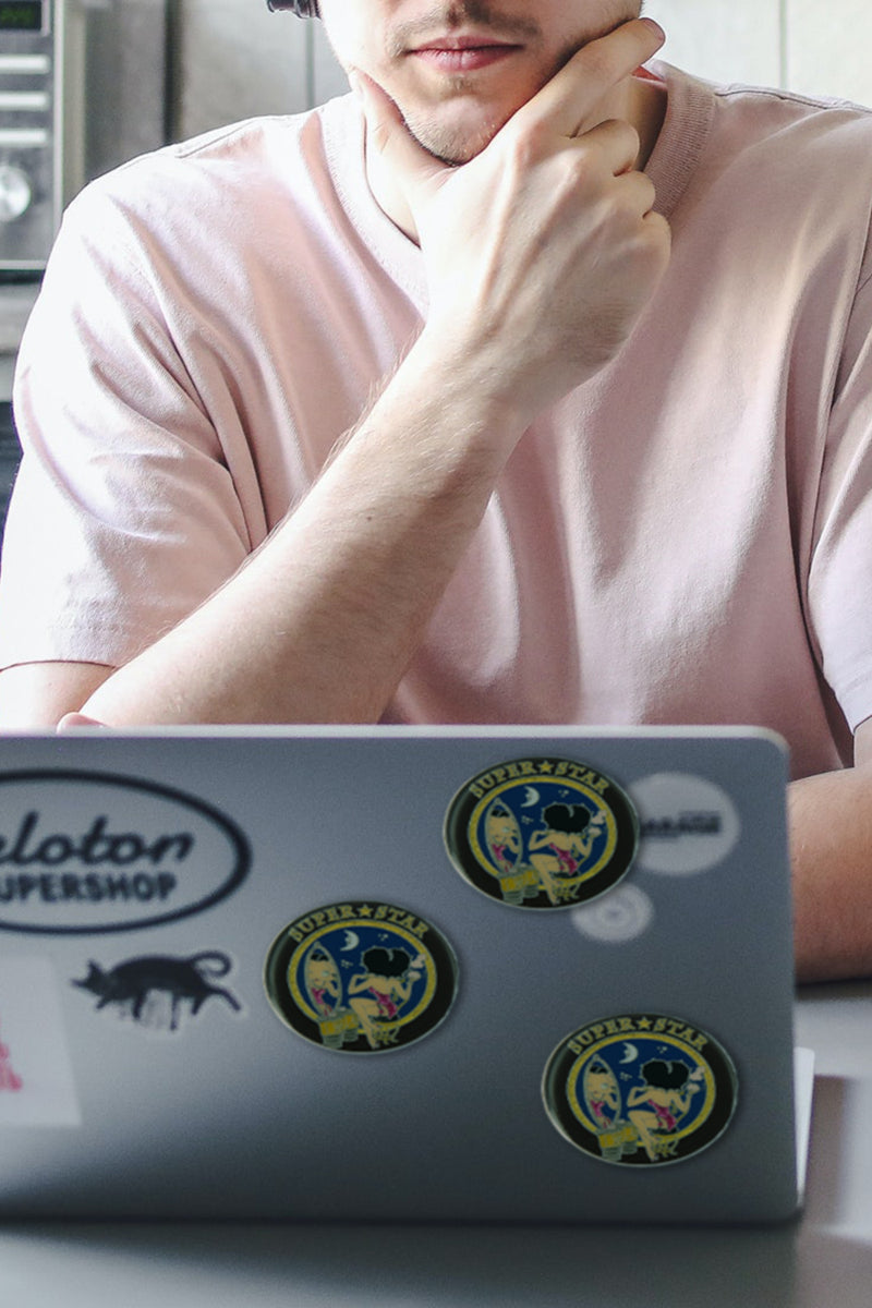 Betty Boop Fridge Magnet Superstar Betty is wearing a bright pink dress and sitting on a stool and looking at the mirror and superstar written on top. This fridge magnet sticks easily to the fridge or any other magnetic surface where magnets can stick to.  Exclusively Available at Reliance Gifts www.reliancegifts.co.uk