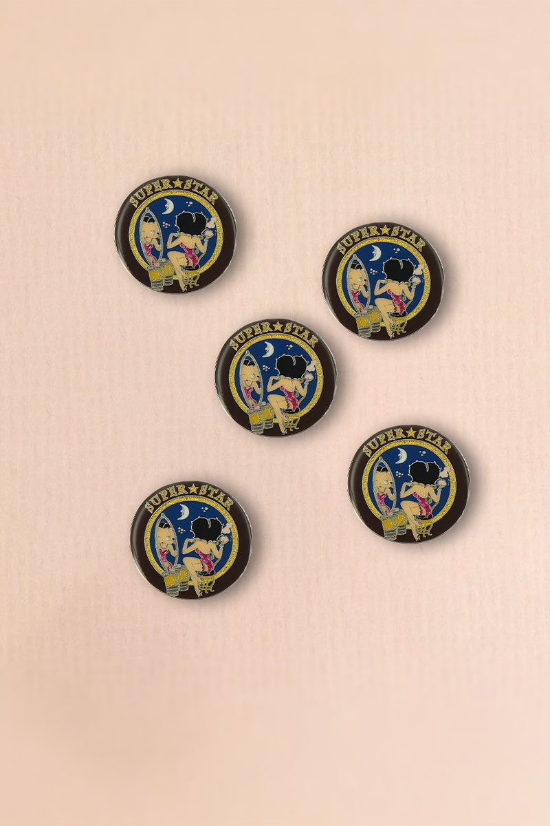 Betty Boop Fridge Magnet Superstar Betty is wearing a bright pink dress and sitting on a stool and looking at the mirror and superstar written on top. This fridge magnet sticks easily to the fridge or any other magnetic surface where magnets can stick to.  Exclusively Available at Reliance Gifts www.reliancegifts.co.uk