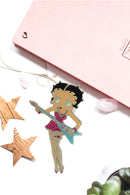 Betty Boop Fridge Magnet Rock Chick Betty is in a pink dress and posing with a guitar. This fridge magnet sticks easily to the fridge or any other magnetic surface.Betty Boop Rock Chic fridge magnet has a fine quality craftsmanship. Exclusively Available at Reliance Gifts www.reliancegifts.co.uk